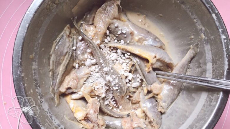 酸辣香酥小黄鱼,腌制好的鱼加入适量豆粉拌匀。