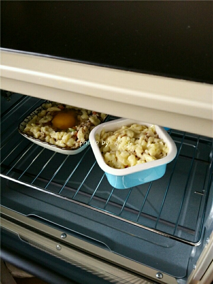 风味蛋焗饭,烤箱预热后，将烤碗放进烤箱中层，关闭烤箱门，烘烤15分钟；