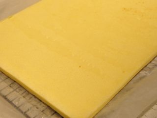 日式豆乳盒子蛋糕,移出蛋糕体，放置在晾网上进行散热，表面轻盖一层油纸，防止蛋糕变干。