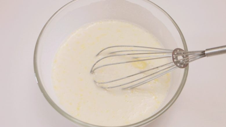 甜心可可麻薯馒头,倒入牛奶和融化的黄油，用手动打蛋器搅拌成均匀的面糊