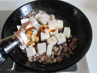 肉末豆米烧豆腐,加入适量的生抽和少许水炖煮；