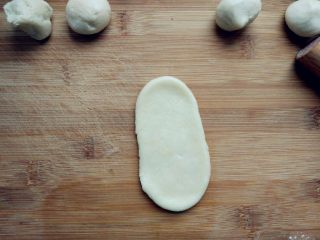 豆沙蛋黄酥,用两手稍揉成长条，用擀面杖小心地擀成长条。擀的时候用力要均匀，以免破皮