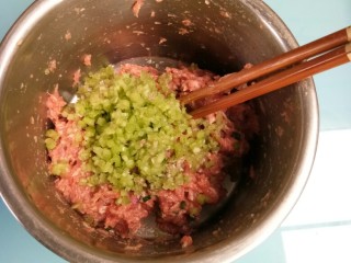 酿南瓜花,把切碎的花梗倒入腌好的肉末中搅拌均匀