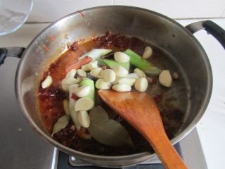 香辣小龙虾,翻炒出红油后，加入葱姜蒜、八角等大料继续翻炒；