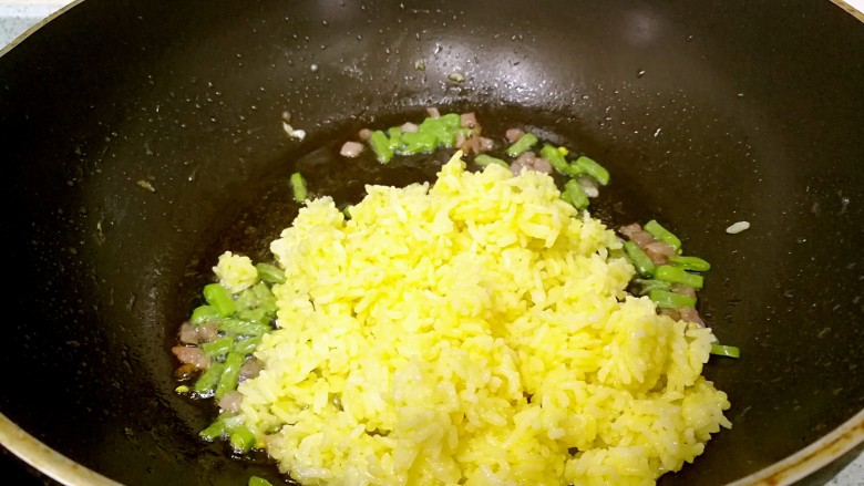 金黄杂锦蛋炒饭,倒入米饭，中小火翻炒均匀。