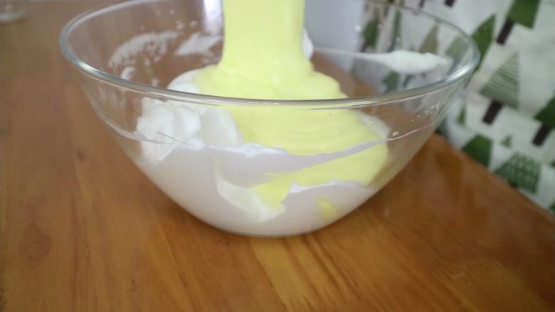 百香果酸奶小纸杯,再将翻拌均匀的面糊倒回剩余的1/2蛋白霜中