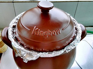 坤博砂锅烤紫薯,盖上锅盖开火(高出锅口的锡纸有利于把多余的水蒸汽排出锅外)。