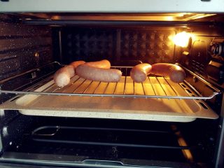 烧麦灌香肠土豆丝饼套餐,剪开后，放入预热好的烤箱中层，上下火150度，开热风烘烤20分钟左右