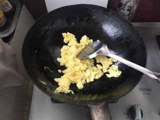 早餐下饭菜,锅中放油烧热将鸡蛋炒散。