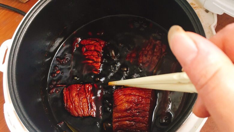 酱香牛肉,煮至15分钟左右，你就能闻到浓浓的香味了，打开盖子，用筷子翻转一下，目的是让牛肉熟透更加均匀