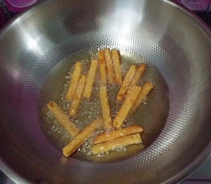 蓝莓酱炸红薯条,待油温升到8成热后重新放红薯条