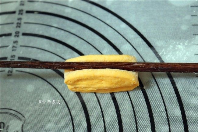 南瓜花卷,取两个面胚，重叠在一起，用筷子在中间轻轻压一下，就成漂亮的花卷，不要用力过度把面团压断