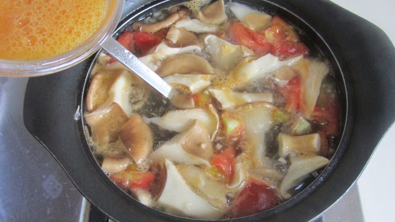 猪肚菇番茄蛋花汤,将搅拌好的鸡蛋液顺着勺子流下去，蛋液浮起来关火；