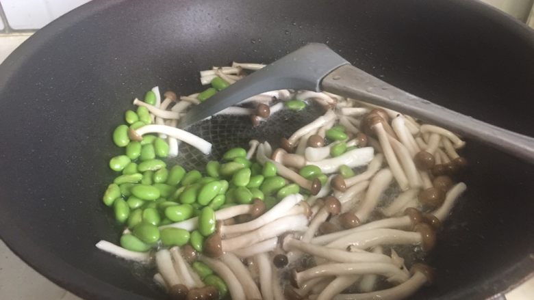 六月黄疙瘩汤,起油锅放入毛豆籽和蟹味菇煸炒片刻