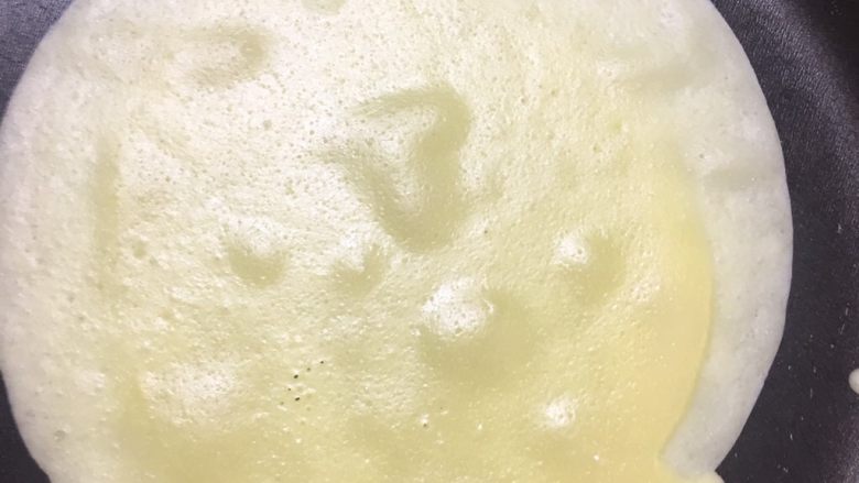 芒果季之可丽饼,倒入面糊，迅速提锅让面糊自然摊开。面糊起较大的泡泡，起锅，平铺。按相同的步骤多煎几张。