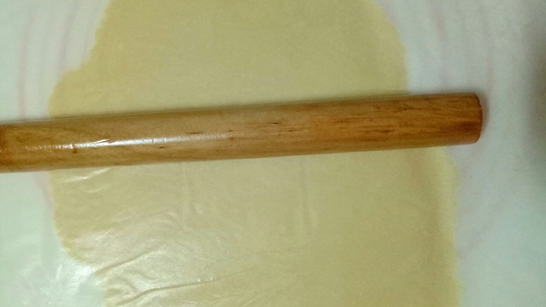小熊抱杏仁饼干,面团上下垫上油纸，用擀面杖擀薄，约2mm左右。