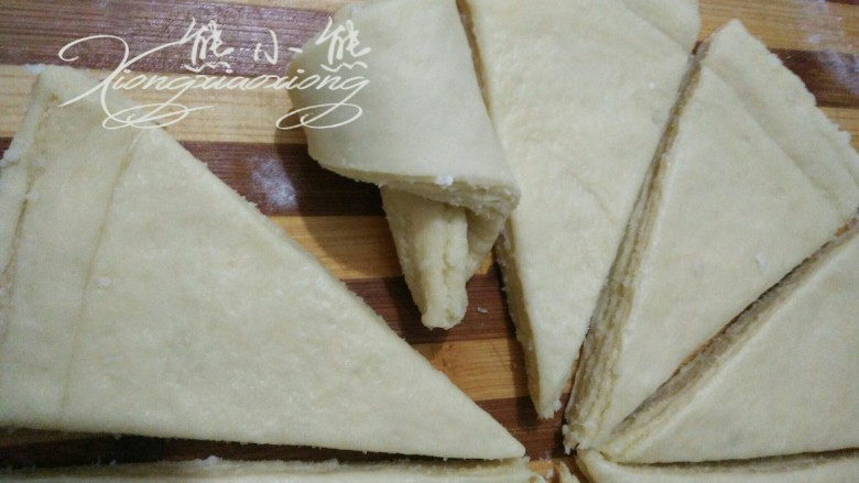 椰蓉手撕面包,从等腰三角形的底开始卷，卷的时候依着一边对齐。