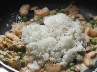 椰子海鲜芝士焗饭,最后把煮好的米饭倒入锅内，翻炒均匀；