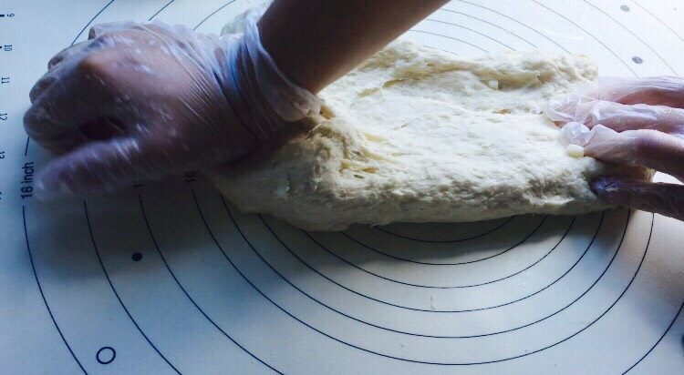 椰蓉面包,移至揉面垫再次搓揉，像洗衣服一样来回搓，折腾，让它快速吸收水分！
