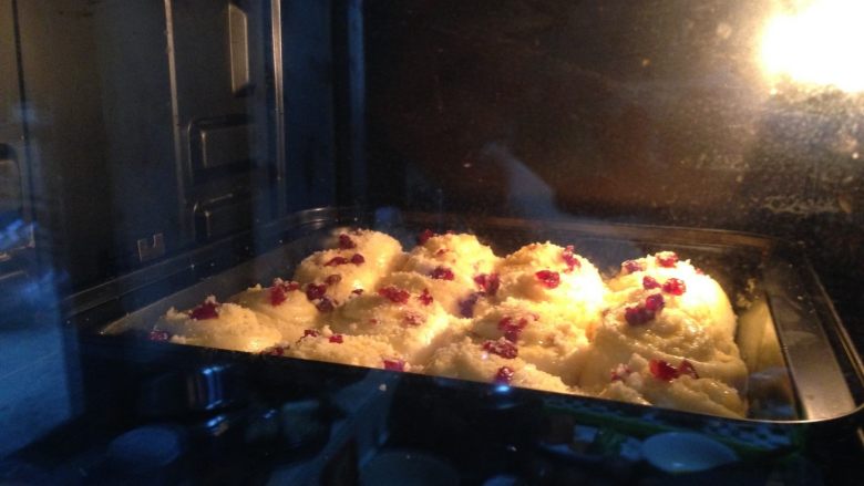 酥粒蔓越莓奶酪卷,将烤盘送入预热好的烤箱中层，180度约20分钟