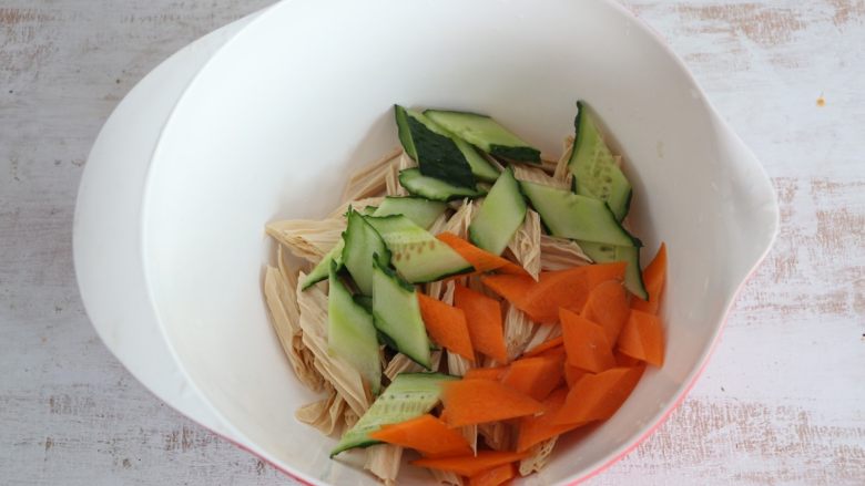 夏日清新小凉菜-凉拌腐竹,将腐竹、黄瓜、胡萝卜放入一个大碗内。