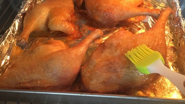 奥尔良烤鸭腿,烤30分钟的时候，打开烤箱，取出烤鸭腿，烤盘上面会有一层烤鸭腿的油，用这个油把鸭腿表面刷一下，这样烤出的鸭腿色泽金黄，油亮亮的
