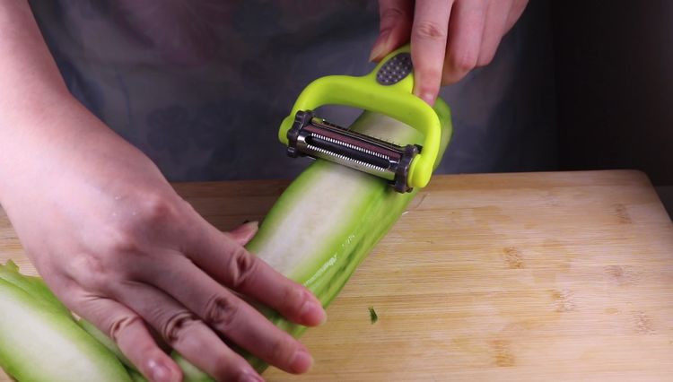 丝瓜换种新鲜做法，比炒蛋还要好吃百倍,将去皮后的丝瓜洗净后，用刮皮刀刮成薄片备用。