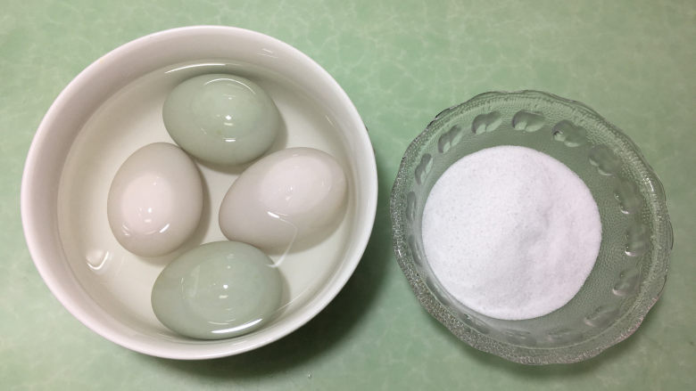 在家也能腌出流油的咸鸭蛋,先将几个鸭蛋放入高度白酒的碗中浸泡1-2分钟。