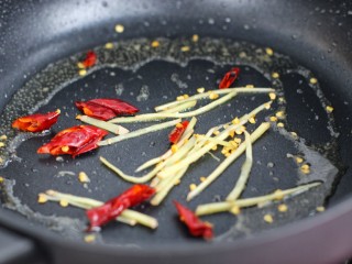 芹菜土豆炒肉丝,用锅中底油炒香姜丝和红干椒