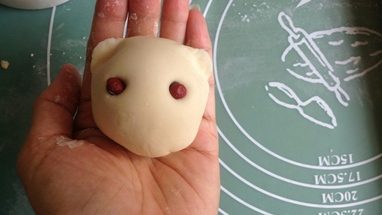 凯蒂猫豆沙包,用拇指和食指在两边捏出耳朵，将红豆按入两边做眼睛。