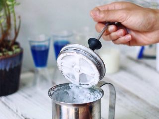 蓝天冰沙,将牛奶倒入手打奶泡壶，快速抽打至奶泡满杯，静置分层。