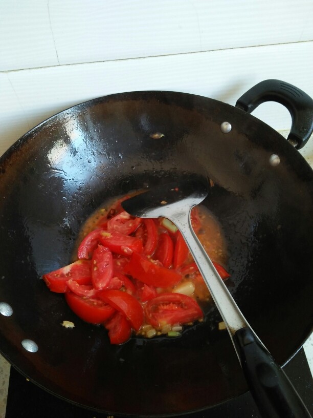 西红柿炖鲫鱼,把西红柿放进去翻炒，自己家种的西红柿就会出很多的水。