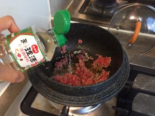 番茄茄丁肉酱拌面,热锅，倒油，烧热以后放入蒜末爆香，放入肉末，加一勺料理酒或者绍兴酒，快速滑开翻炒到全部变色。
