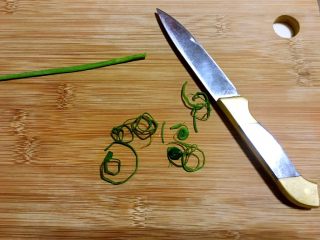 六月黄炒年糕,小葱只取绿叶部分，卷起来之后，切成葱丝装饰。
