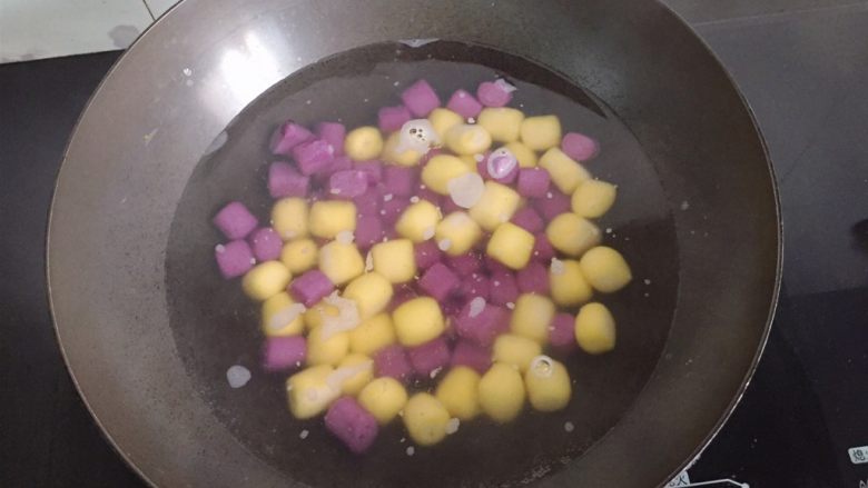 紫薯南瓜双色芋圆,锅中加水烧开，将芋圆放进去煮。