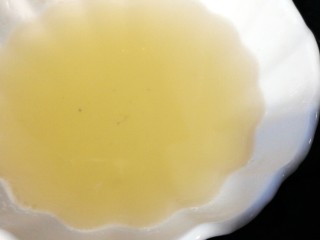 鲜美的蛤蜊鸡蛋羹,在煮蛤蜊的水中晃动漂去杂质，蛤蜊入另一碗中。煮蛤蜊的汤倒入汤碗中，让汤沉淀一下。
