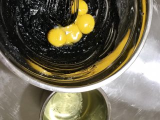 黑·竹炭咸奥利奥蛋糕卷,蛋黄和蛋白分离，蛋黄加入面糊中，用手动打蛋器拌匀，蛋白放到另一个无油无水的打蛋盆中