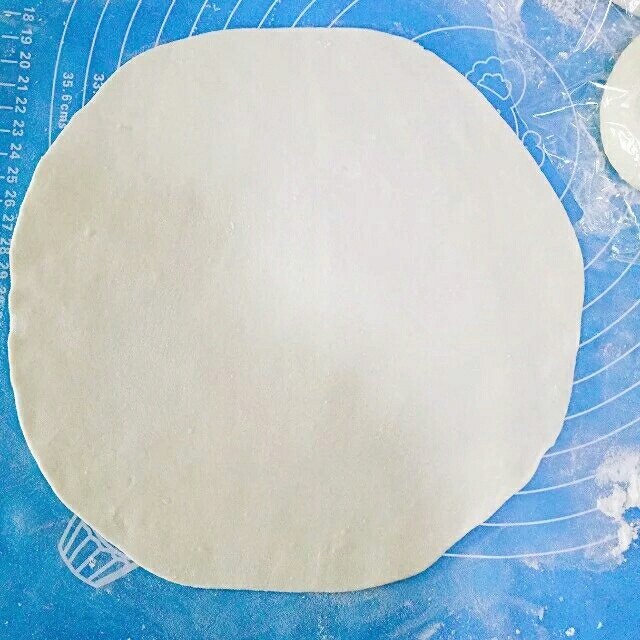 韭菜鸡蛋饼,取一个剂子，下面撒少许干面粉，赶成薄薄的的圆皮