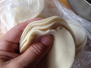 豆角猪肉饺,
买来的饺子皮用手把四周捏薄一些（中间厚四周略薄）