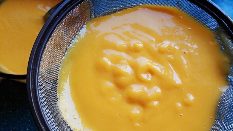 芒果布丁,把混合好的芒果牛奶过筛。