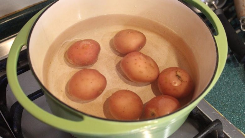 柠檬大蒜脆烤土豆,将土豆放入煮锅，加入盖过土豆的水量，加入约半大匙的盐。