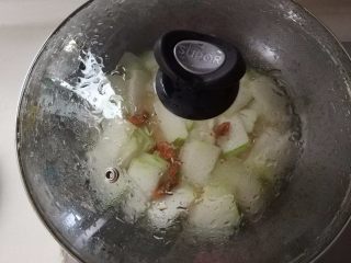 虾味冬瓜,加入少量的水（冬瓜本身含水量很多，在这里加入少量的水就可以了），盖上盖子，焖煮至冬瓜熟。