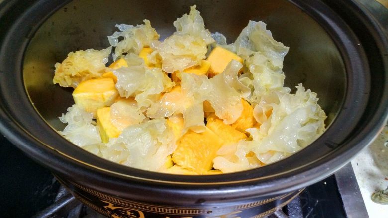  银耳南瓜汤,把银耳撕成小块和南瓜一起放在砂锅里。