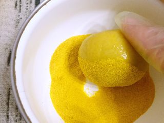 韩式南瓜🎃小月饼,将南瓜月饼胚表面均匀滚上南瓜粉，薄薄一层就可以。