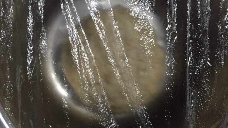 100%全麥麵包,靜置，蓋保鮮膜第一次發酵。夏天室溫30度以上的，40分鐘至1個小時。現在大部分烤箱都有發酵功能，40度，半小時左右。記得放碗熱水增加濕度。