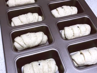 无糖全麦红豆黑米餐包,收口朝下放入模具内，在稳度38度，湿度75%的环境中进行最后发酵