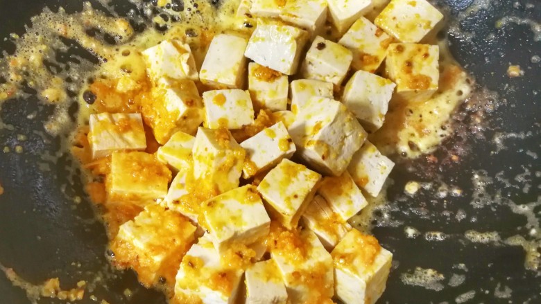 蟹黄味的咸蛋黄烧豆腐,放入焯过水的豆腐，翻炒均匀，