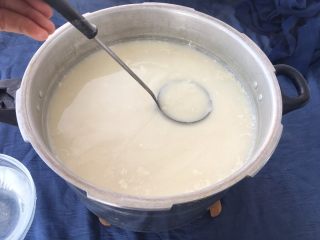 手工自制豆腐～纯天然无添加,用小勺舀半勺胆巴水沿豆浆上面打转，打7～10回转内把胆巴水加入豆浆中，注意看豆花形成。