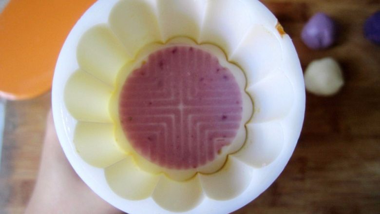 低糖低油【紫薯冰皮月饼】,取一点点步骤6的紫色面团压入50G一个（10头）的月饼模具的花纹中作为配色