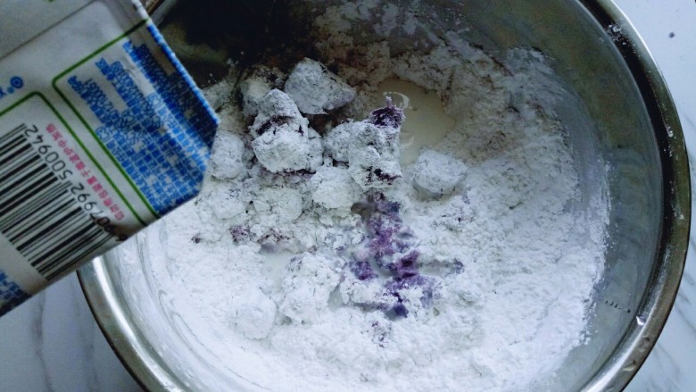 芝士紫薯球#附紫薯泥制作#,分次加入牛奶，用筷子挑成絮状。